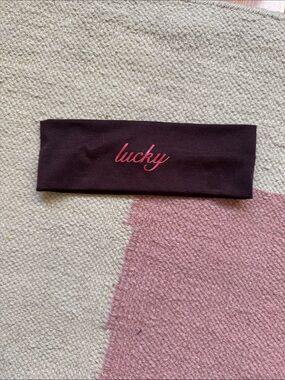 “Lucky” Brown Headband with red lucky' Script